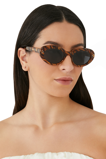 نظارة شمسية بإطار بيضاوي ونقشة شعار الماركة