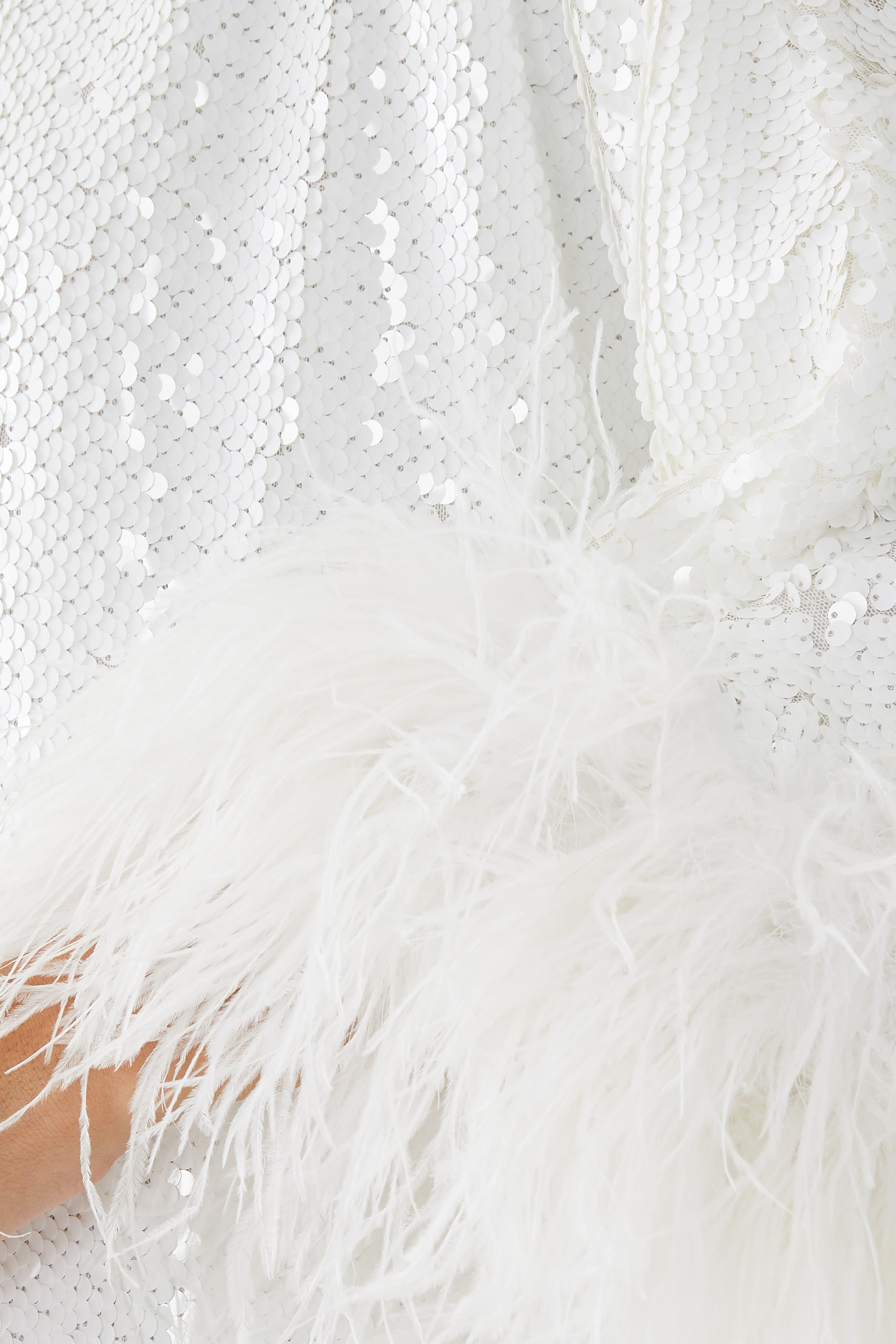 فستان طويل مزين بالترتر والريش