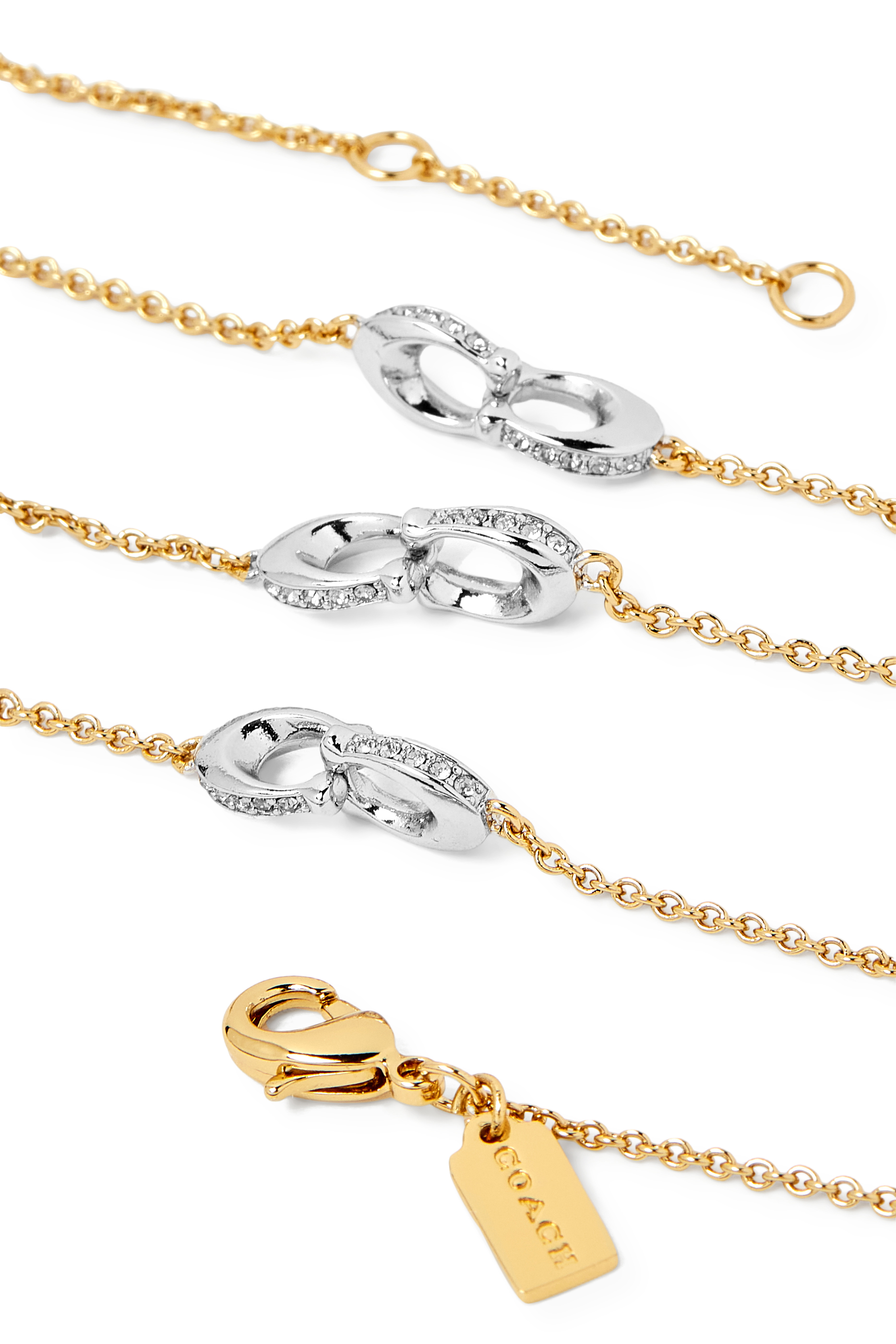 قلادة بسلاسل عدة وحلية بشعار الماركة مرصعة بكريستال، معدن