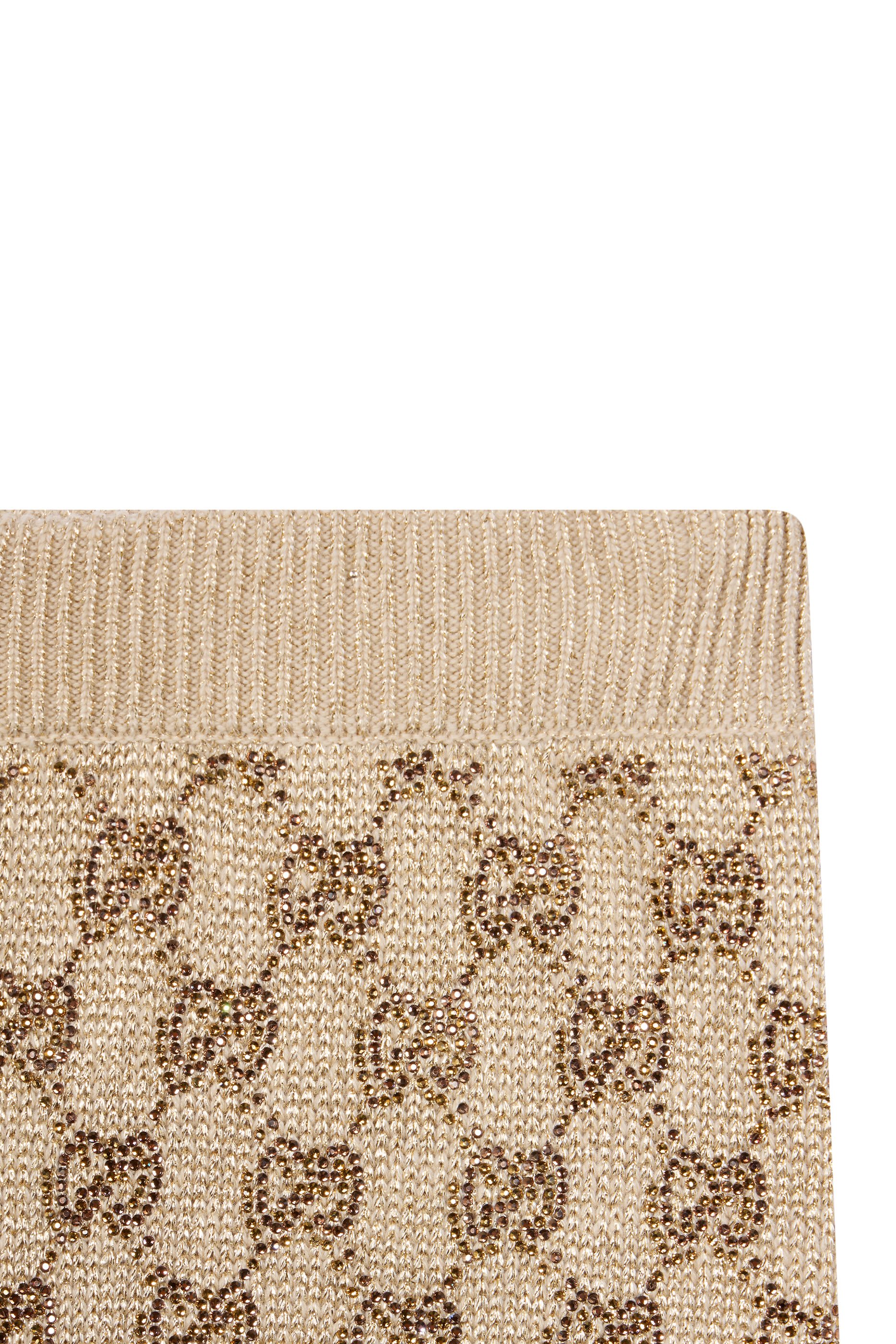 بنطال ليجر بنقشة شعار حرفي الماركة مرصع بالكريستال بالكامل 