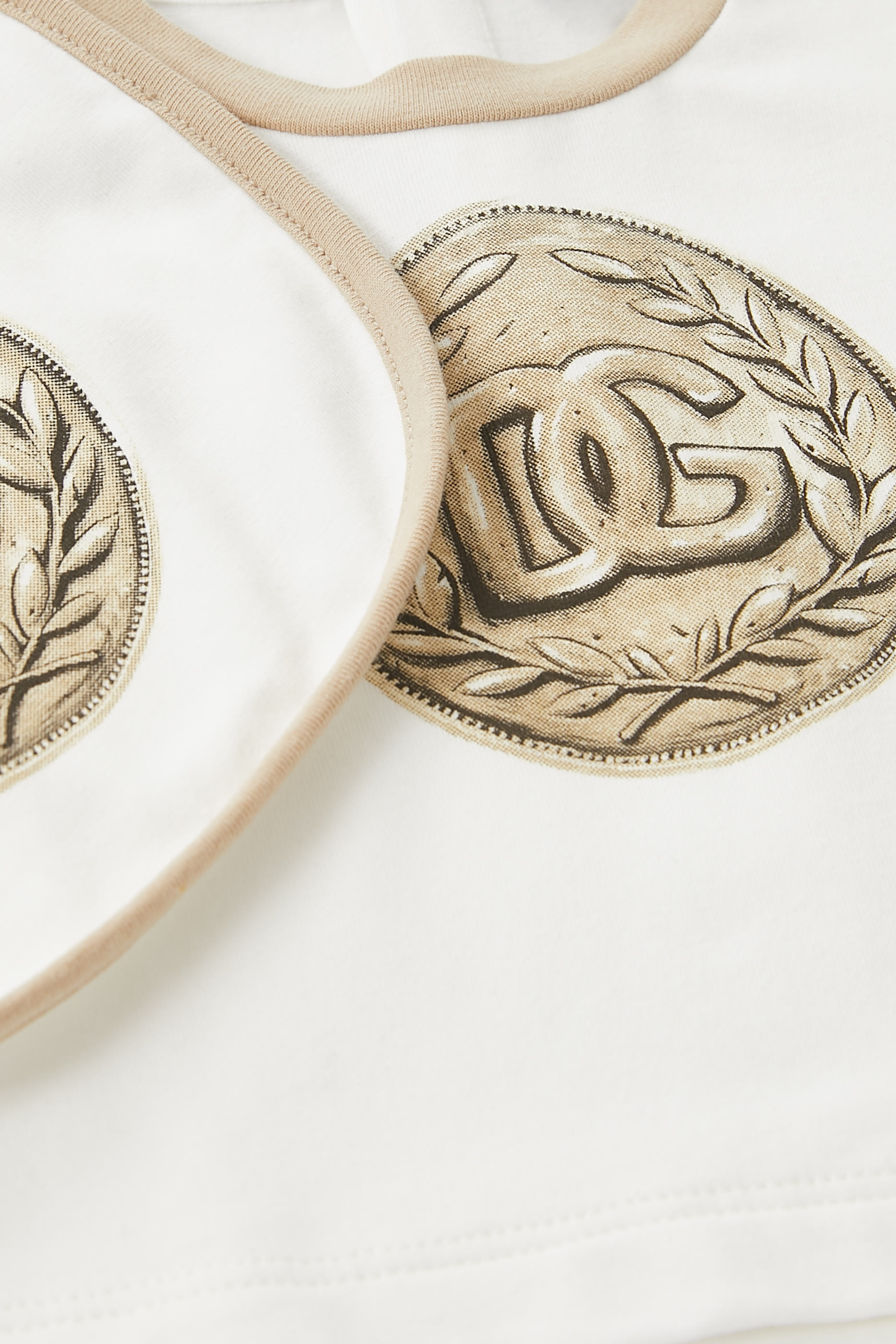 طقم بودي سوت ومريلة للأطفال بطبعة عملة